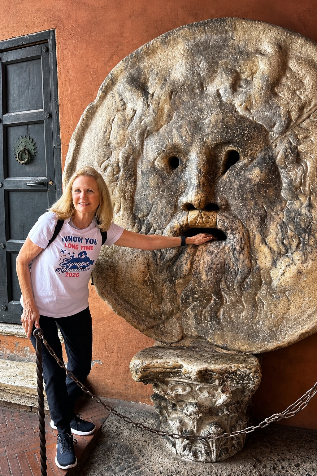 Progressive Traveller at the Mouth of Truth, Rome Progressive Traveller placing her hand inside the Mouth of Truth (Bocca della Verità) in Rome, Italy.